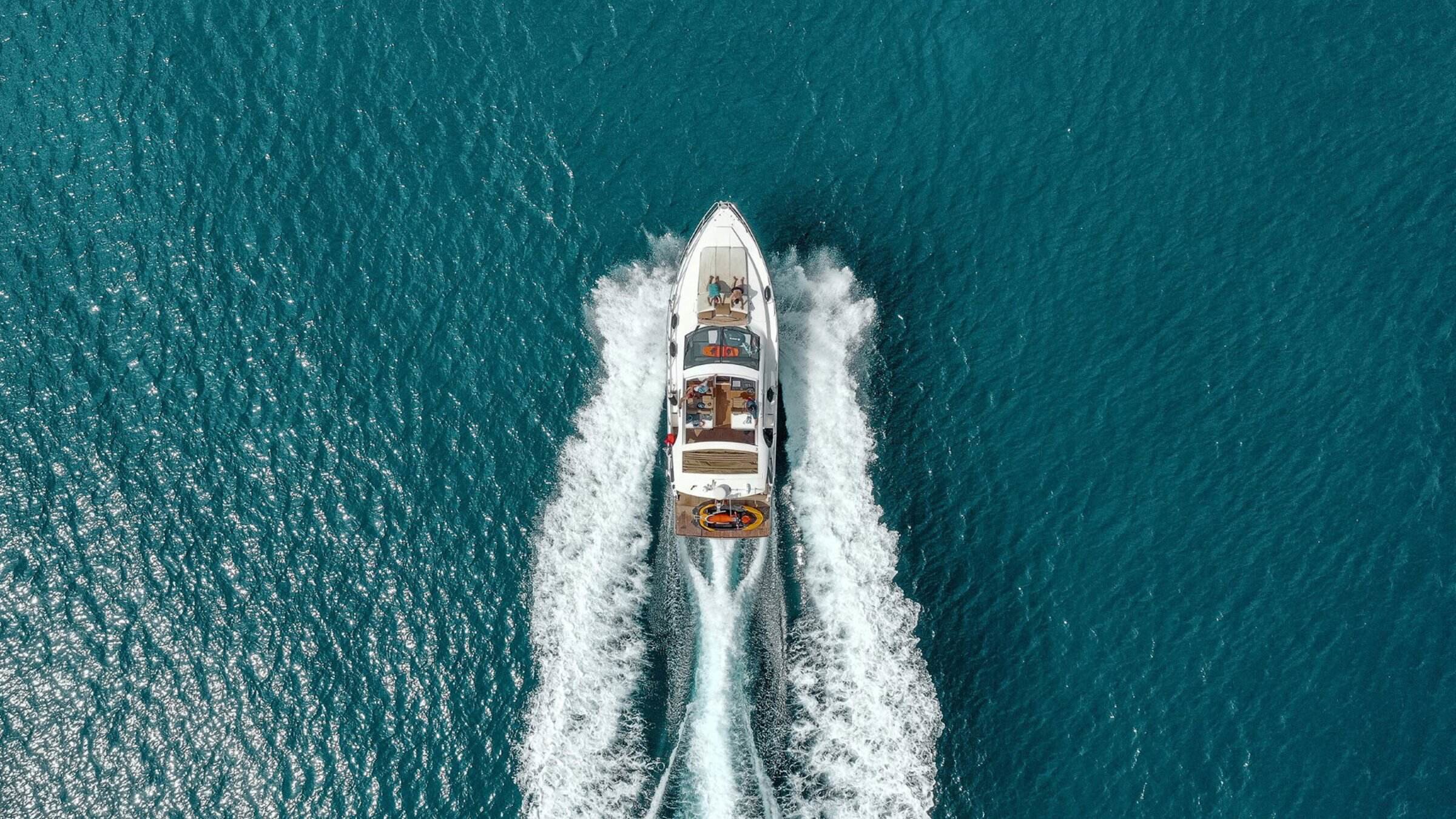 A Group On Boat Sailing On Sea, Clear Water